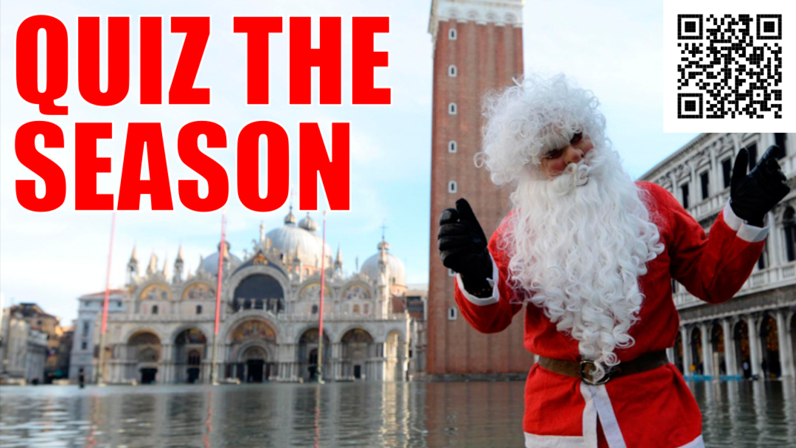 Man dressed as Santa Claus waving at the camera while up to his knees in floodwater in St Mark's Square, Venice - caption: QUIZ THE SEASON